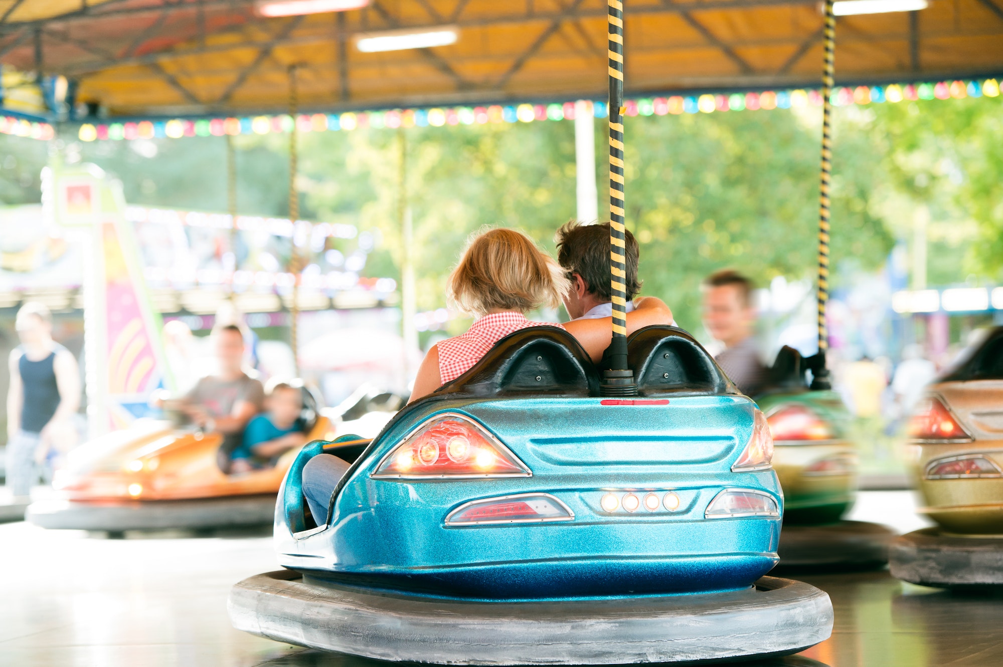 Senior couple in the bumper car at the fun fair